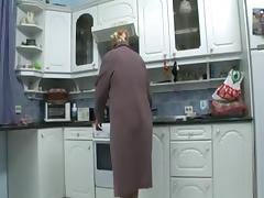 grandmother masturbates in the kitchen