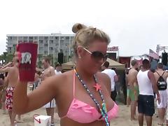Affectionate drunkard babes in miniskirt posing seductively at the beach outdoor