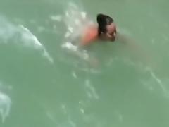 A voyeur tapes swingers having a threesome at a nude beach