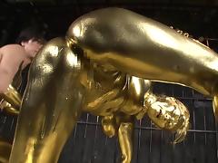 She is covered in gold paint then she gets fucked by a golden guy