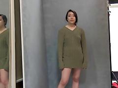 Asian girl in a loose sweater looks sexy posing for pics