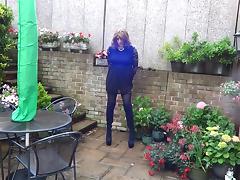 Wanking and plugged in the garden in thigh high boots