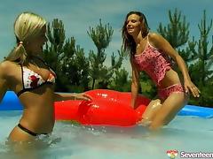 Lesbian cutie has her coochie throbbed with a toy at the pool