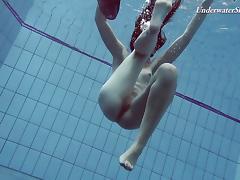 Slender raven-haired stunner undresses while diving in the pool