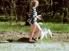 Beautiful college girl takes  a walk with the dog